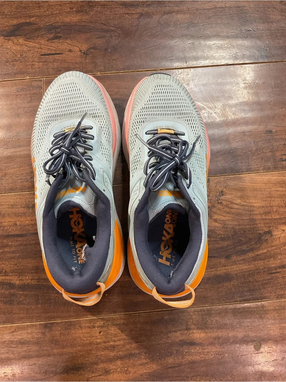 Hoka Blue Athletic Shoes with Orange and Pink Accents